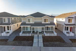 Townhome / multi-family property featuring a porch and a mountain view