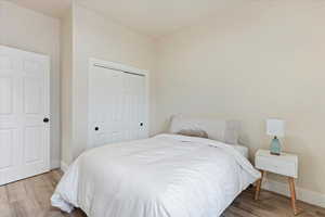 Bedroom featuring a closet and light hardwood / wood-style flooring