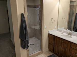 Bathroom featuring vanity and a shower with shower door