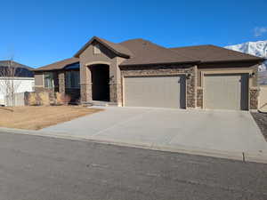 View of front of house featuring a mountain view and a garage