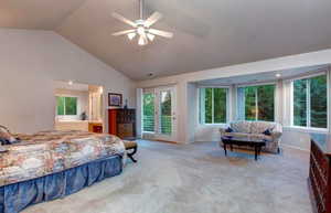 Bedroom with access to outside, vaulted ceiling, ceiling fan, and light colored carpet