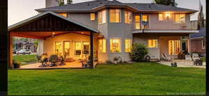 Rear view of property featuring a yard, a patio, and a balcony