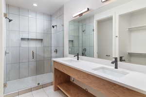 Bathroom featuring vanity, tile patterned flooring, and walk in shower