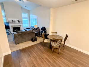 Dining area with LVP floors, vaulted ceiling, and ceiling fan