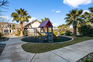 View of jungle gym with a lawn