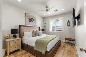 Bedroom with ceiling fan and light hardwood / wood-style flooring