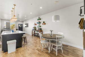 Dining space featuring light wood-type flooring and sink