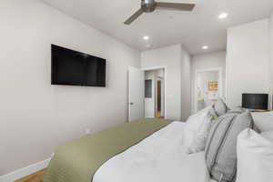 Bedroom featuring connected bathroom, ceiling fan, and hardwood / wood-style flooring