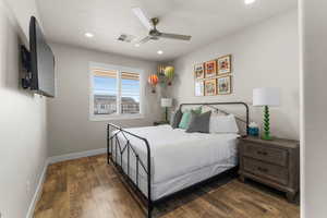 Bedroom featuring ceiling fan and dark wood-type flooring