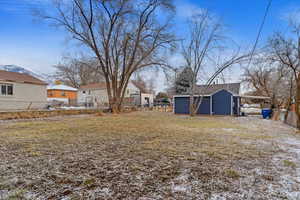 View of yard with a shed and a carport