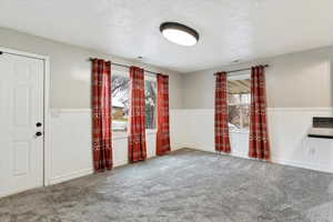 Spare room with carpet flooring and a textured ceiling