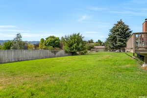 View of yard featuring a mountain view with canal on other side of back fence