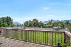 Wooden terrace with a lawn and a mountain view