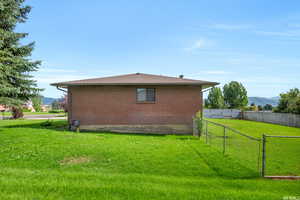 View of home's exterior with a lawn and a mountain view