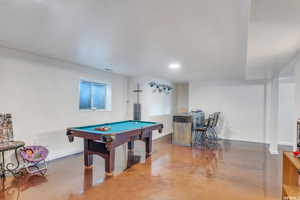 Playroom featuring concrete flooring, indoor bar, and pool table