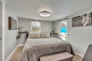 Carpeted bedroom with a textured ceiling