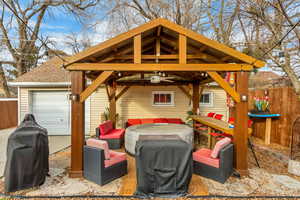 View of patio with a gazebo, ceiling fan, and area for grilling