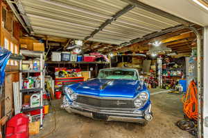 Garage with gas water heater, electric heat and shop