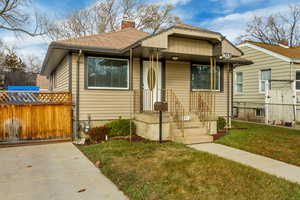 Bungalow-style house with a front yard