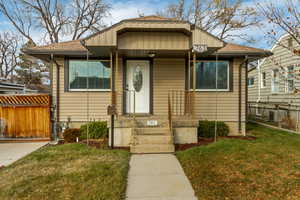 Bungalow-style home with a front lawn