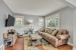 Living room with dark hardwood / wood-style flooring