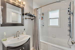 Bathroom with vanity and shower / bathtub combination with body jets