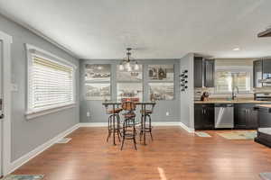 Dining area, open concept to living room and kitchen, light hardwood / wood-style flooring.