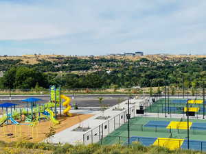 View of tennis court with a playground