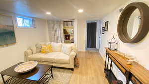 Living room with light hardwood / wood-style floors