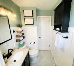 Bathroom featuring toilet, vanity, and tile patterned floors