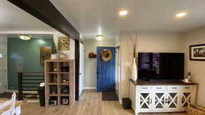 Entryway featuring wood-type flooring and a textured ceiling