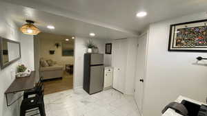 Kitchen with white cabinets and stainless steel fridge