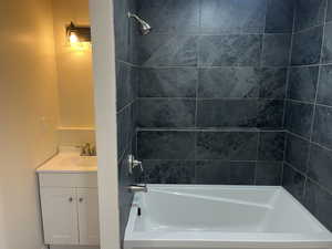 New basement Bathroom with vanity and tiled shower / bath combo