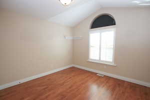 Bedroom 3  featuring hardwood / wood-style floors and vaulted ceiling