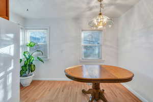 Dining room featuring light hardwood / wood-style flooring and an inviting chandelier