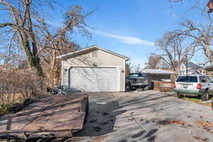 View of property exterior with an outbuilding and a garage