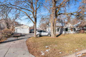 View of home's exterior featuring a garage and a lawn