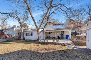 Back of property featuring a lawn and a patio