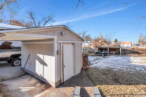 View of outdoor structure with a carport