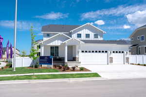 View of front of house with a garage and a front yard