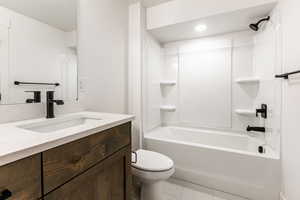 Full bathroom featuring tile patterned flooring, vanity, shower / bathtub combination, and toilet