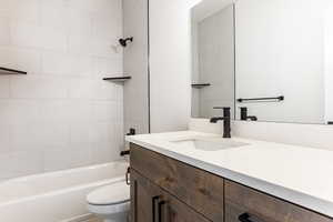 Full bathroom with vanity, toilet, and tiled shower / bath