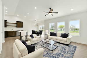 Living room with recessed lighting, a wealth of natural light, and light wood-type flooring