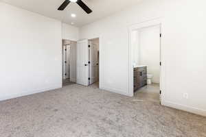 Unfurnished bedroom with light carpet, ensuite bath, and ceiling fan