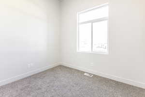 Unfurnished room featuring carpet flooring