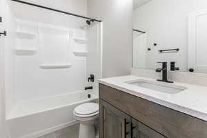 Full bathroom featuring tile patterned flooring, vanity, toilet, and shower / bathing tub combination