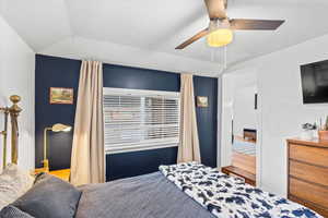 Bedroom with ceiling fan and lofted ceiling