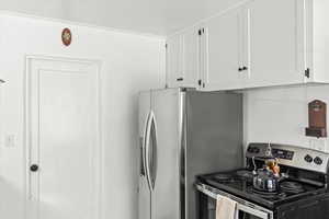 Kitchen featuring white cabinetry and stainless steel appliances