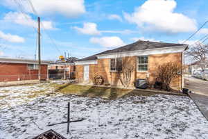 Snow covered house with central AC