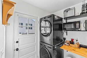 Laundry area featuring stacked washer / dryer